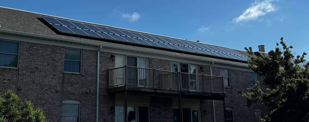 Rooftop solar panels on Cambridge Place Apartments in Iowa City, helping reduce energy costs