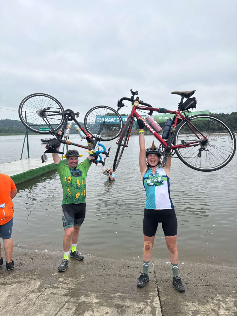 RAGBRAI cyclists posing with their bikes at an end town stop